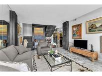 Bright living room with marble floors, modern decor, and plentiful artwork on display at 145 15Th Ne St # 409, Atlanta, GA 30309