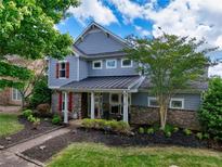 Charming two-story home with stone accents, well-maintained landscaping, and inviting curb appeal at 207 Harmony Lake Dr, Canton, GA 30115