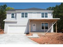 Two-story home with gray siding, white trim, an attached garage, and a covered front porch at 2462 Adair Ridge Ct, Decatur, GA 30034