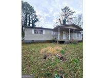 Single story home with covered porch and a traditional, simple exterior design at 9135 Ford Sw St, Covington, GA 30014