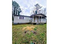 Charming single-story home featuring a covered porch and a traditional design at 9135 Ford Sw St, Covington, GA 30014