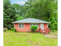Cozy one-story home with charming front porch and mature trees at 551 Barnes Mill Dr, Marietta, GA 30062