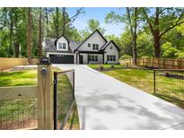 Beautiful two-story home with a long driveway and a gated entrance at 2263 Barge Rd, Atlanta, GA 30331