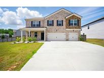 Charming two-story brick home featuring a spacious driveway and attached two-car garage at 2804 Torunn Ct, Atlanta, GA 30331