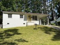 Charming single-story home with a large grassy front yard and attached carport at 782 Alfred Nw Rd, Atlanta, GA 30331
