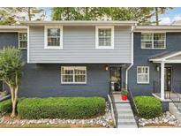 Charming townhouse with gray and blue brick and manicured landscaping and front steps at 3147 Buford Ne Hwy # 2, Atlanta, GA 30329