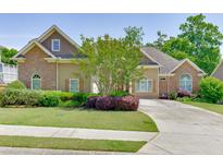 Charming single-story home with a well-manicured lawn, mature trees, and a paved driveway at 2041 Democracy Dr, Buford, GA 30519