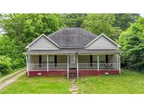 Charming single-story home with a welcoming front porch and lush green lawn at 232 S Candler St, Villa Rica, GA 30180