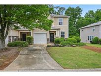 Inviting two-story townhome features charming curb appeal and an attached one car garage at 505 Rendezvous Rd, Acworth, GA 30102