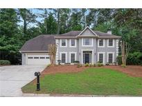Charming two-story home with a manicured lawn and a two-car garage at 1368 Christiana Dr, Lawrenceville, GA 30043