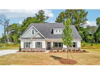 Charming single-story home features a welcoming front porch, green shutters, and landscaped yard at 1471 Stephens View Dr, Loganville, GA 30052