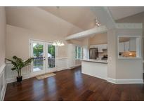 Bright dining area with hardwood floors, adjacent to kitchen and featuring French doors to outdoor deck at 102 Peaceful Vw, Acworth, GA 30102