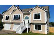 Charming two-story home featuring an inviting entryway and an attached two-car garage at 102 Peaceful Vw, Acworth, GA 30102