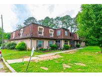 Charming multi-Gathering home with lush green lawn and manicured landscaping and inviting curb appeal at 2986 Parc Lorraine, Lithonia, GA 30038