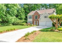 Charming two-story home with a well-manicured lawn, a two-car garage, and a long driveway at 190 Crestworth Ct, Powder Springs, GA 30127