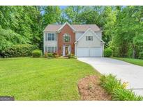 Traditional two-story home with brick accents and a well-manicured lawn and driveway at 190 Crestworth Ct, Powder Springs, GA 30127