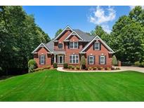 Beautiful brick home with black shutters, lush landscaping and a well manicured lawn at 7251 Bluewater Ln, Douglasville, GA 30135