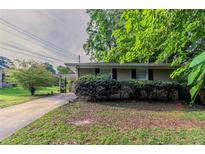 Charming single-story home with a covered carport, tidy landscaping, and a brick facade at 4029 Moffat Ct, Decatur, GA 30035