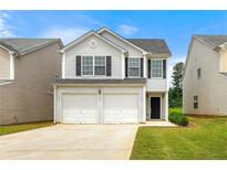 Charming two-story home featuring a two-car garage and well-maintained lawn at 7495 Garnet Dr, Jonesboro, GA 30236