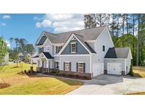 Charming two-story home with a two car garage and lush green lawn at 1452 Stephens View Dr, Loganville, GA 30052