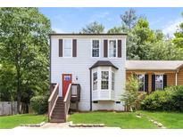 Charming home featuring a red front door, bay window, and elevated front porch at 3474 Kingswood Run, Decatur, GA 30034