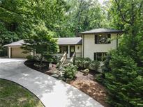 Charming two-story home with white brick and a lush, landscaped front yard at 1053 Crane Ne Rd, Atlanta, GA 30324