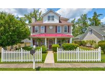 Charming two-story home with a white picket fence and manicured landscaping at 2707 Mariner Way, Villa Rica, GA 30180