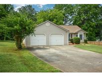 Charming single-story home featuring a two-car garage and a well-maintained front lawn at 3217 New Rutledge Nw Rd, Kennesaw, GA 30152