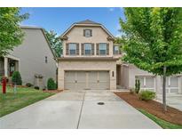Charming two-story home with a brick facade, a two-car garage, and a well-maintained lawn at 1347 Elderwood Way, Cumming, GA 30041