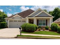 Charming single-story home featuring a well-maintained lawn, attached garage, and inviting front porch at 2058 Bonneville Ln, Powder Springs, GA 30127