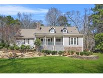Charming single-Gathering home with stone accents, dormer windows and a beautifully landscaped front yard at 65 Deer Run Ln, Mcdonough, GA 30252