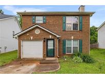 Charming brick home with green shutters and a one-car garage at 3949 Riverside Pkwy, Decatur, GA 30034