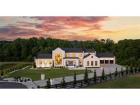 Stunning modern farmhouse with a three car garage, black framed windows, and a lush green lawn at sunset at 5160 Howard A Rd, Cumming, GA 30040