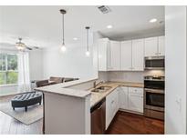 Bright kitchen features granite countertops, stainless steel appliances, and hardwood floors at 10 Perimeter Summit Ne Blvd # 4243, Brookhaven, GA 30319