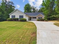 Charming single-story home with a well-maintained lawn and classic curb appeal in a wooded neighborhood at 145 Shadowbrook Trce, Covington, GA 30016