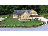 Charming home featuring a well-manicured lawn and lovely landscaping at 128 Graybrook Ct, Grayson, GA 30017