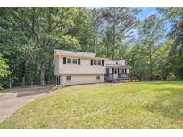 Charming two-story home with a well-maintained lawn and mature trees, providing a serene and inviting curb appeal at 155 S South Meadowcliff Cir, Carrollton, GA 30116