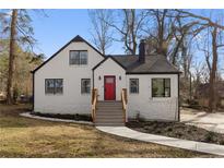 Charming renovated house features a bright red door, black trim, and newly landscaped front yard at 1870 Avon Sw Ave, Atlanta, GA 30311
