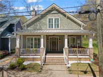 Charming two-story home with a welcoming front porch, brick accents, and manicured landscaping at 958 Austin Ne Ave, Atlanta, GA 30307