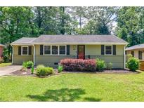 Charming single-story home featuring a well-manicured lawn and colorful, updated landscaping at 2985 Westbury Dr, Decatur, GA 30033