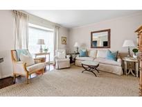 Cozy living room with neutral tones, plush seating, and bright natural light from large window at 136 Peachtree Memorial Nw Dr # Nh4, Atlanta, GA 30309