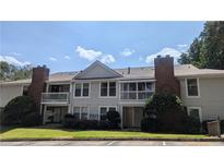 Attractive condominium building with large balconies, brick accents, and well-manicured lawn at 1371 Keys Lake Ne Dr, Brookhaven, GA 30319