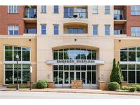 Emerson Overlook building entrance with glass doors, and manicured landscaping at street level at 326 Roswell Se St # 508, Marietta, GA 30060