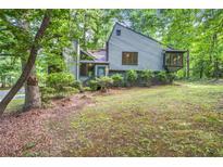 Charming home with unique architectural details surrounded by mature trees at 1909 Winding Creek Sw Ln, Marietta, GA 30064