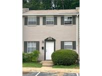 Charming townhome with three windows and front door with dark shutters and greenery at 4701 Flat Shoals Rd # 41-F, Union City, GA 30291