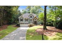 Charming two-story home featuring a well-manicured lawn and inviting curb appeal at 7635 Wynfield Dr, Cumming, GA 30040