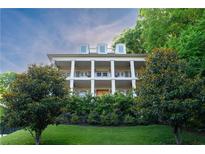 Stately three-story home featuring white columns, balconies, dormer windows, and lush landscaping at 790 Lakeview Ne Ave, Atlanta, GA 30308