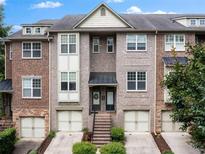 Attractive brick townhome with attached garages and well-maintained landscaping at 1973 Cobblestone Cir, Brookhaven, GA 30319