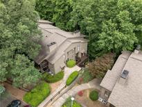 Aerial view of charming two-story townhomes surrounded by lush green trees at 2510 Cumberland Se Ct, Smyrna, GA 30080