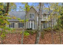 Charming two-story home featuring a well-maintained lawn and inviting front entrance at 7165 Jonsway, Cumming, GA 30041